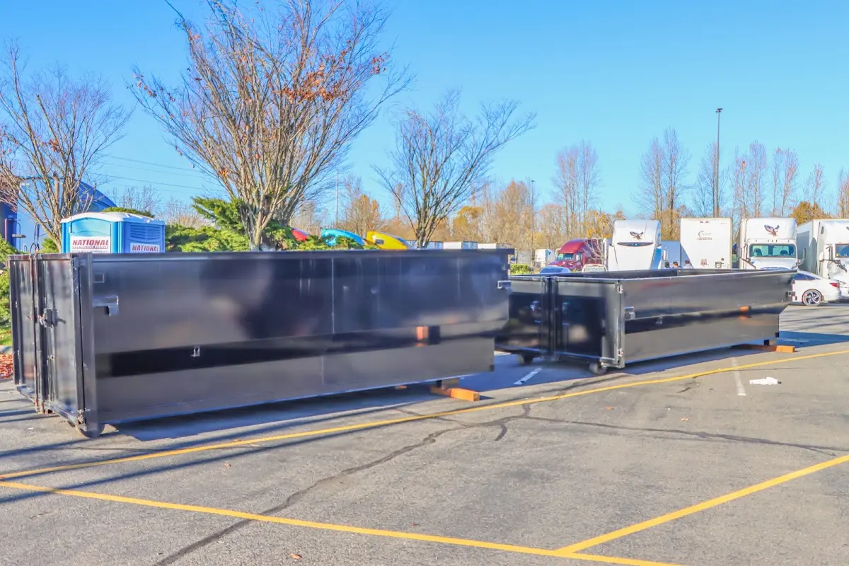 Professional dumpster rental service with roll-off container on residential driveway in Upper Grand Lagoon